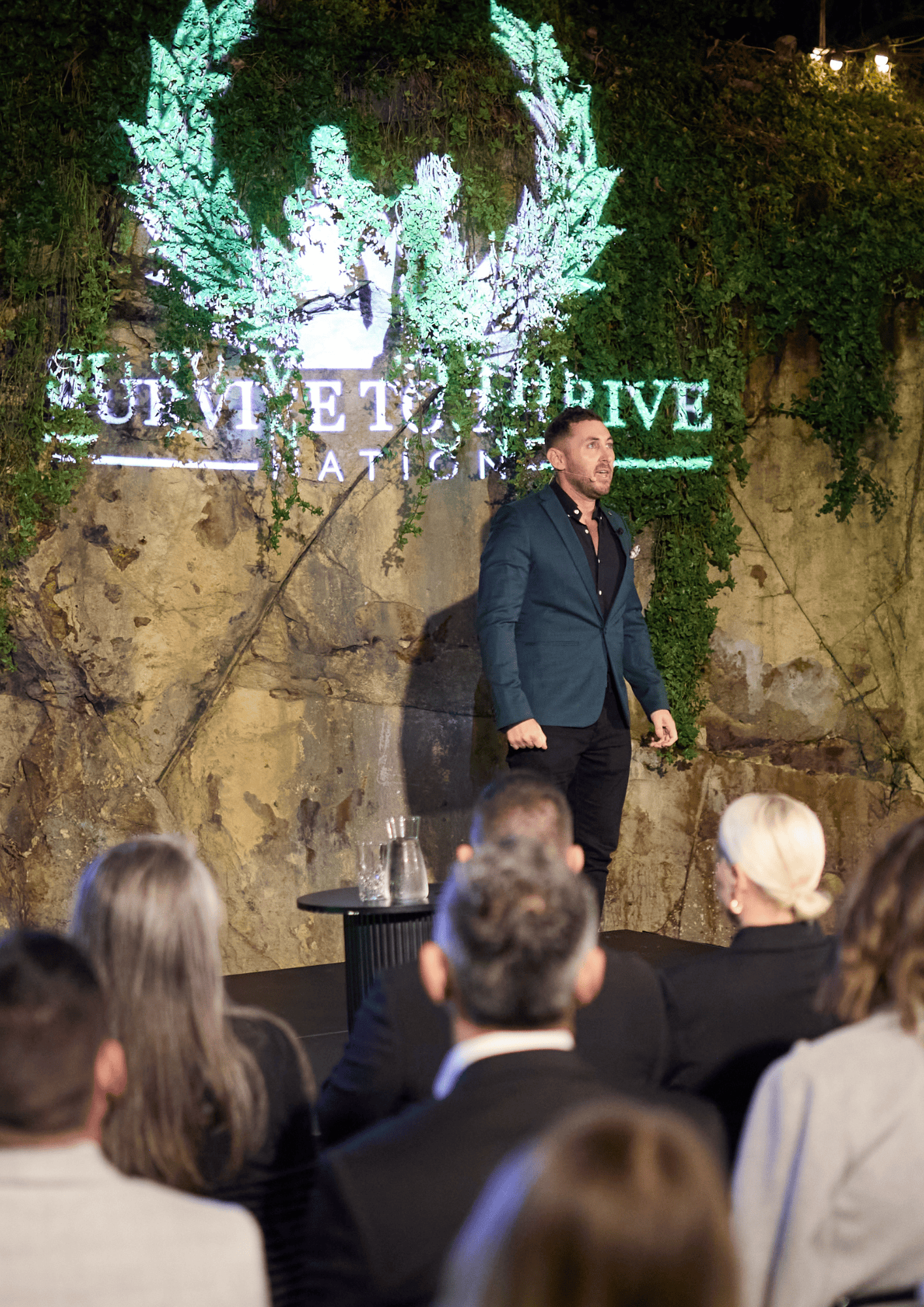 Man on stage speaking at a successful event planned by Lo Key Agency